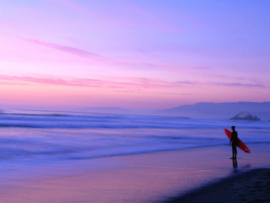 Surfer on Ocean Beach, San Francisco, California, USA