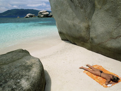 Woman Sunbathing on Beach Beween Rocks, Coco Island, Praslin, Seychelles, Indian Ocean, Africa