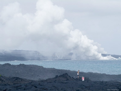 Steam Plumes from Hot Lava Flowing onto the Beach and Hitting the Ocean